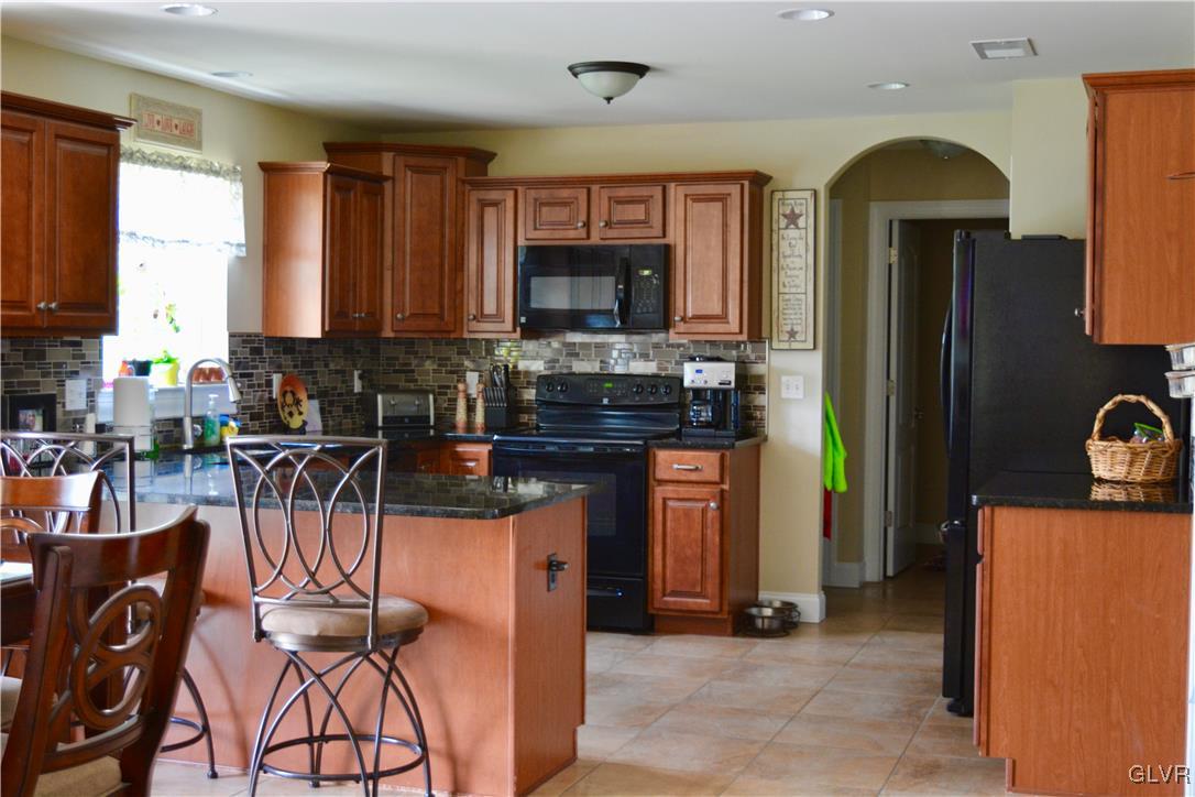 146 Fox Ridge Nazareth, PA 18064 - Photo 7 of 24 a kitchen with stainless steel appliances granite countertop a refrigerator a stove a sink a dining table and chairs