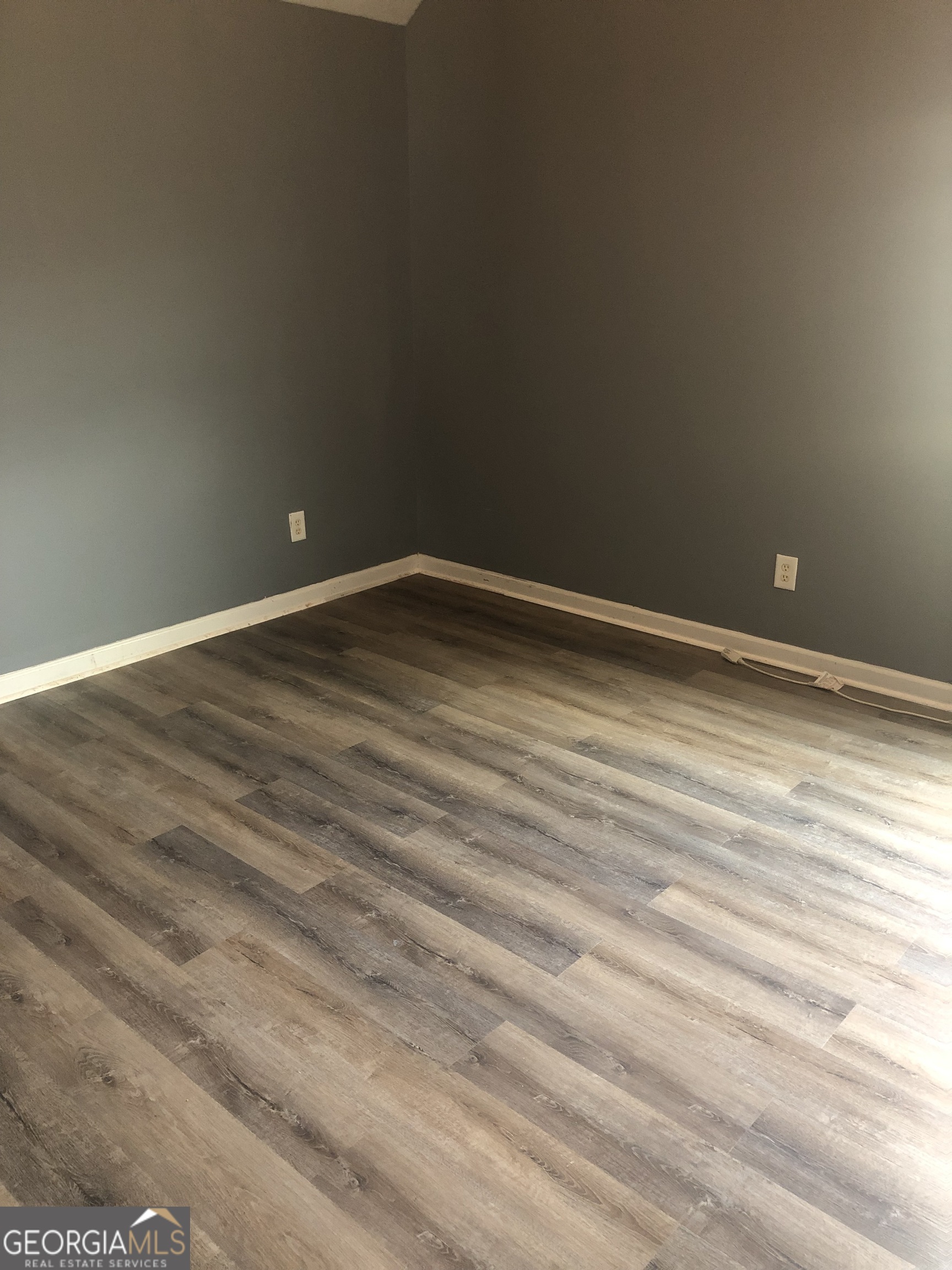 25 Franklin Way Covington, GA 30016 - Photo 23 of 54 a view of empty room with wooden floor