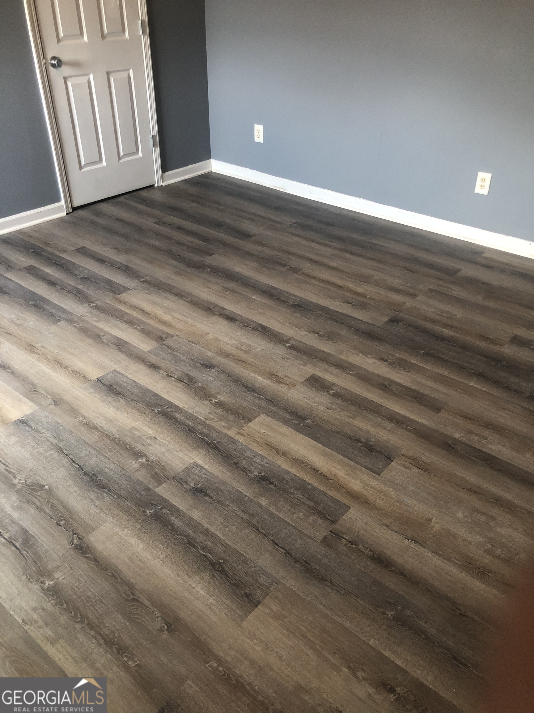25 Franklin Way Covington, GA 30016 - Photo 28 of 54 a view of an empty room with wooden floor