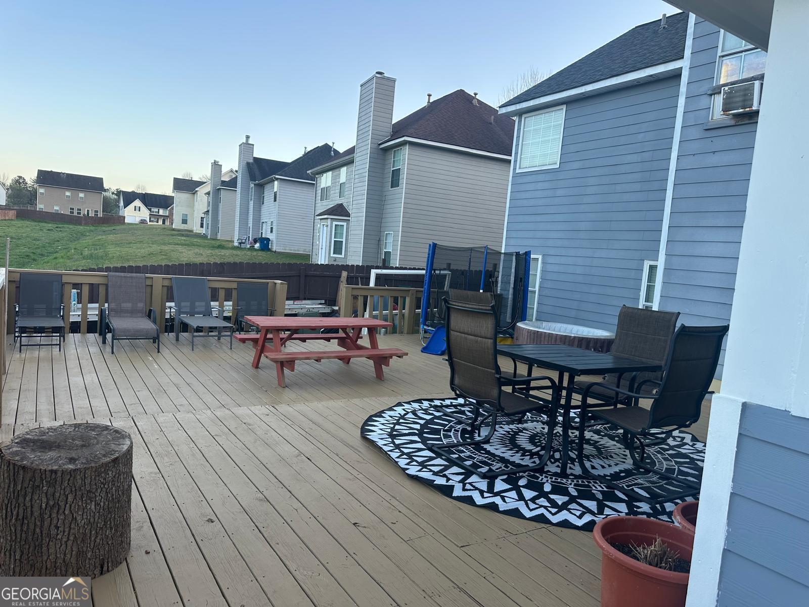 25 Franklin Way Covington, GA 30016 - Photo 40 of 54 a view of a rooftop deck with table and chairs
