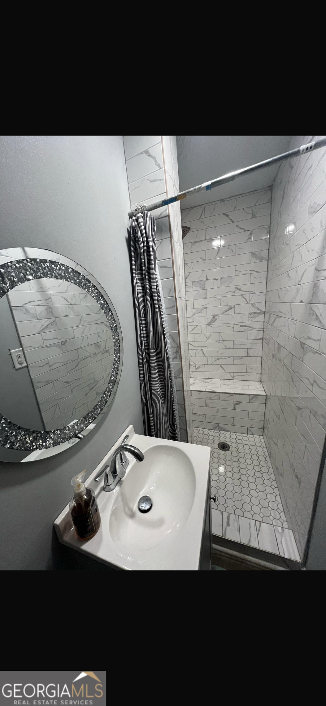25 Franklin Way Covington, GA 30016 - Photo 51 of 54 a bathroom with a sink a mirror and a shower