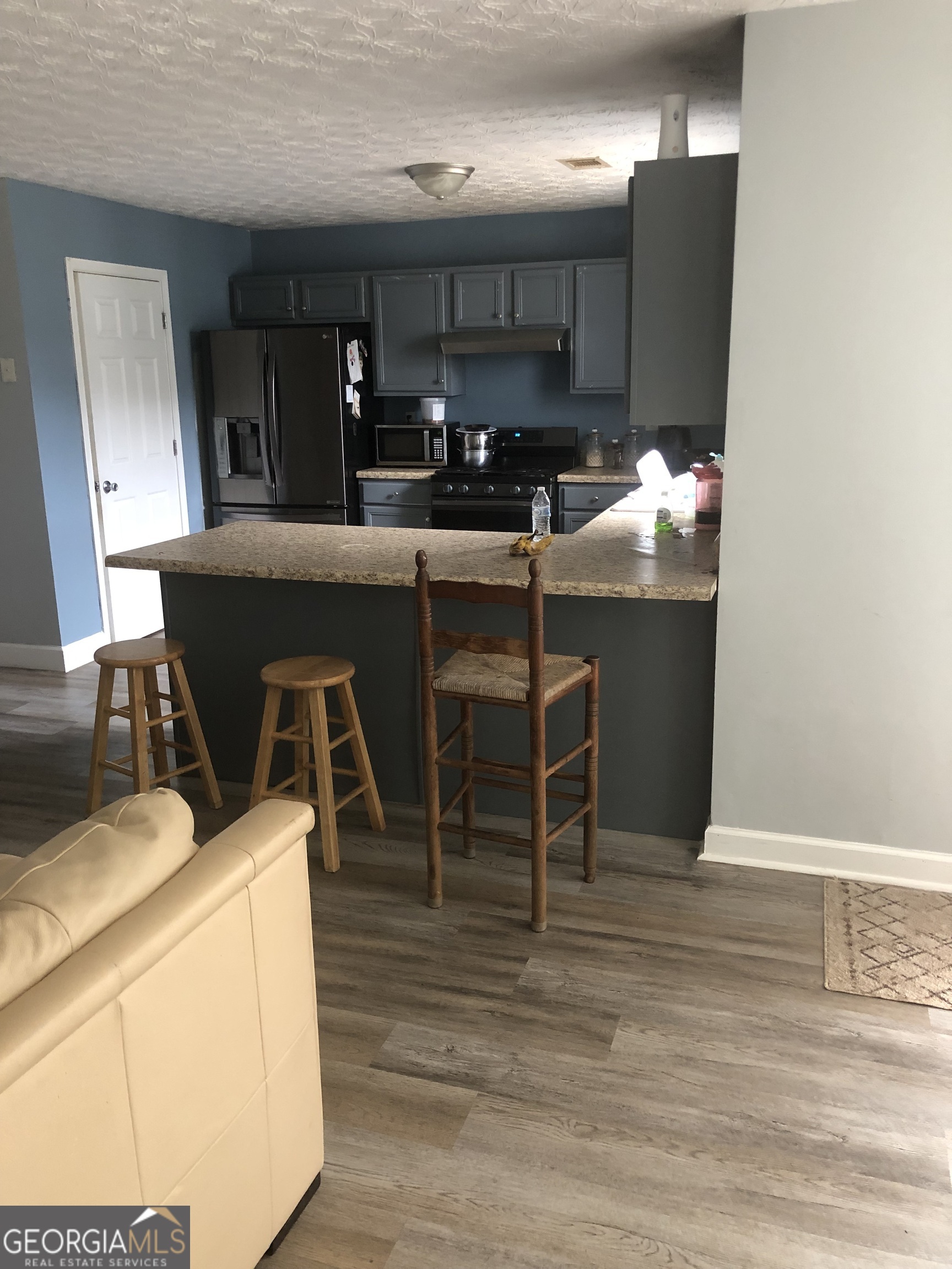 25 Franklin Way Covington, GA 30016 - Photo 8 of 54 a kitchen with granite countertop a sink cabinets and stainless steel appliances