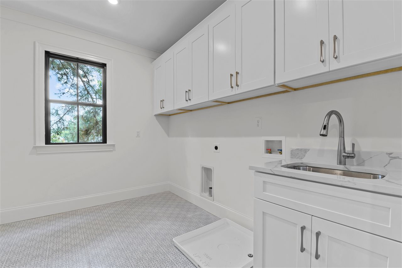 713 Mial Street Raleigh, NC 27608 - Photo 23 of 30 Laundry Room w/ Sink connects from Hall and Primary Closet Laundry Room