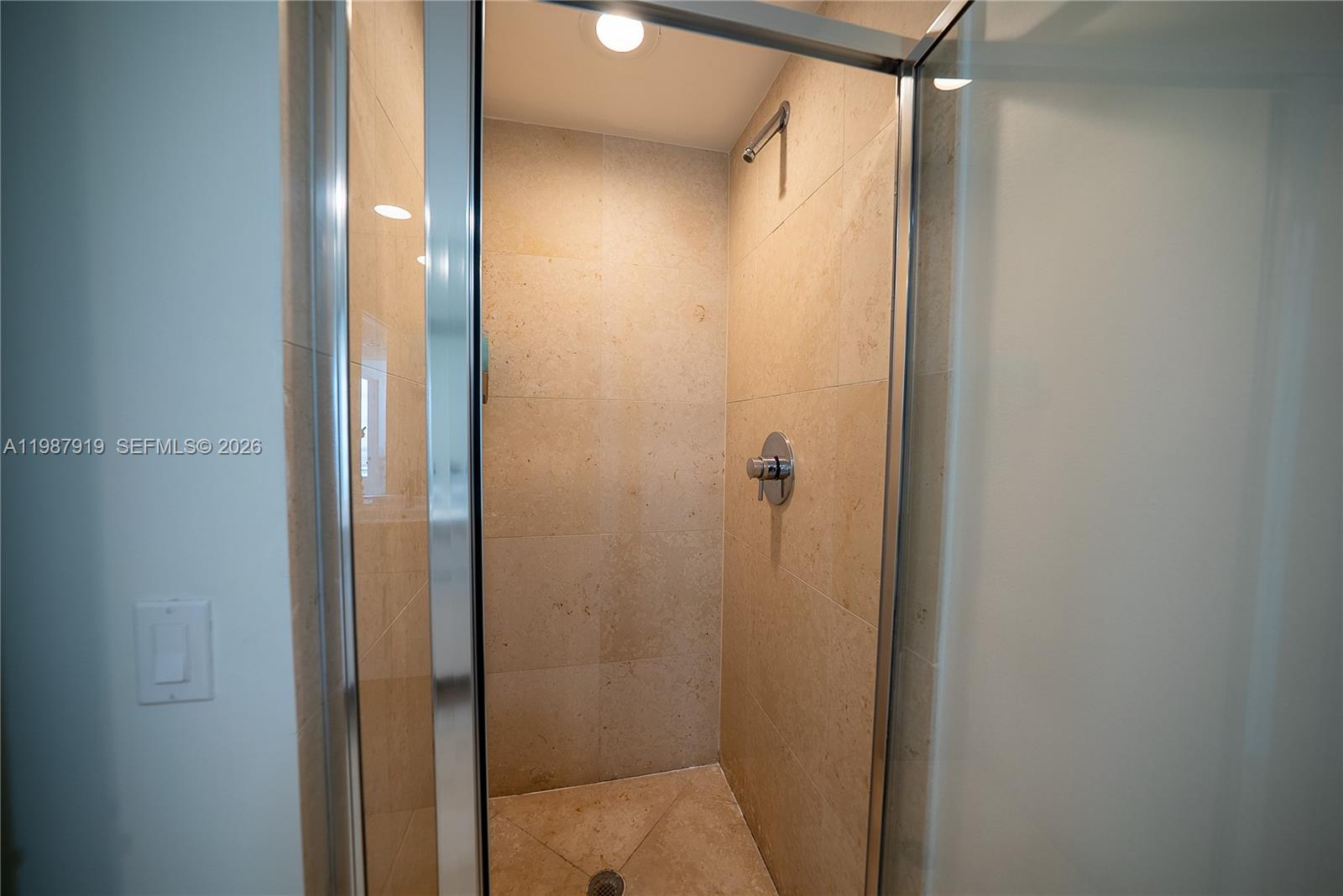 Icon Brickell Miami, FL 33131 - Photo 11 of 26 a bathroom that has a glass shower door