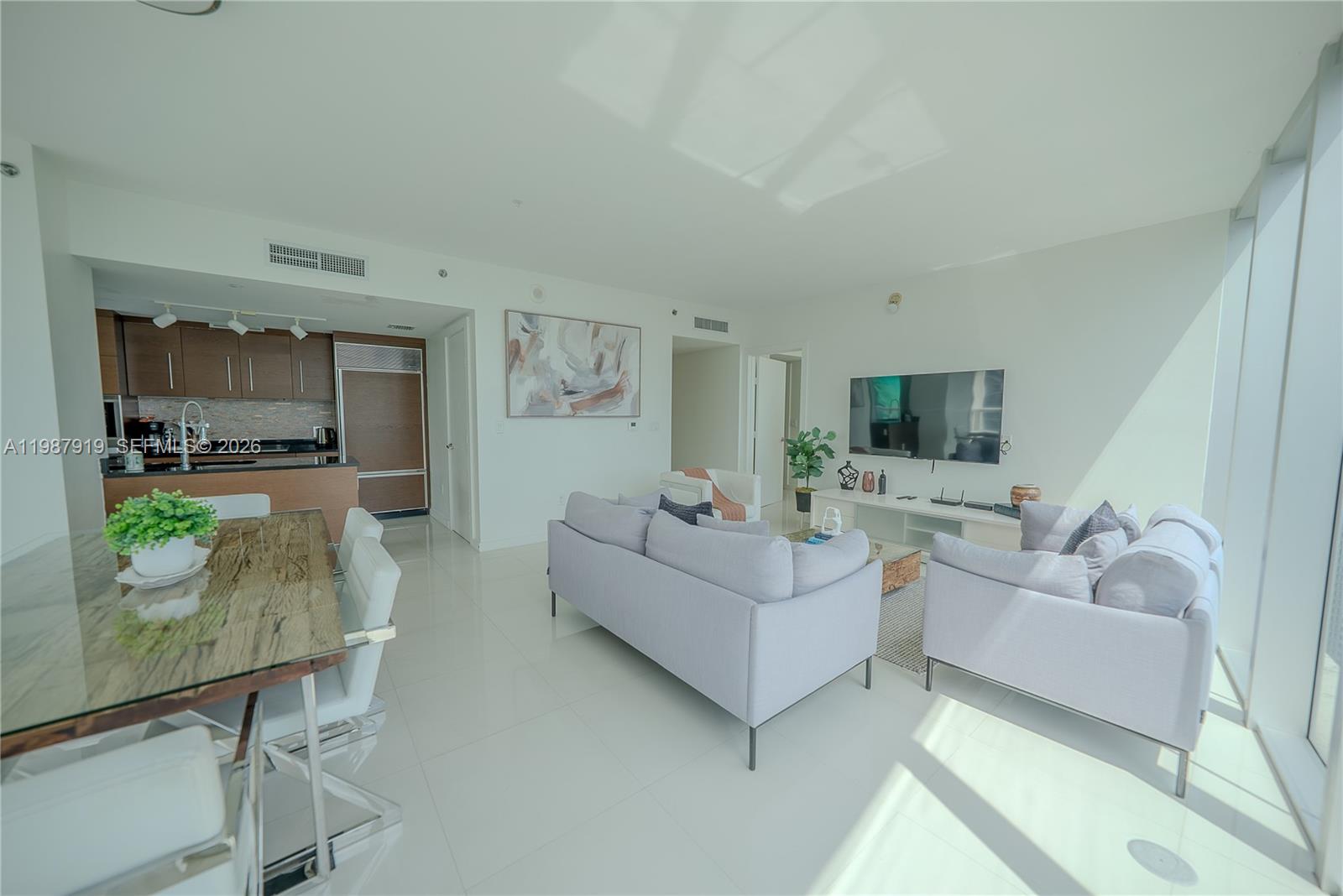 Icon Brickell Miami, FL 33131 - Photo 12 of 26 a living room with furniture and a flat screen tv