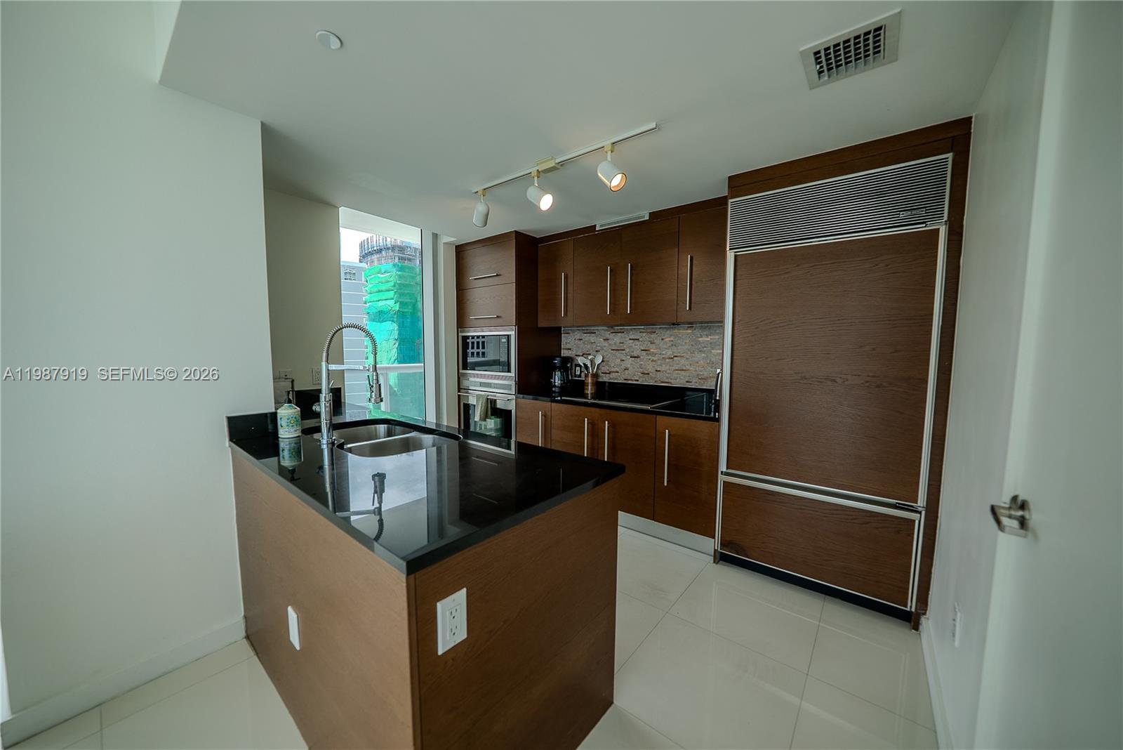 Icon Brickell Miami, FL 33131 - Photo 13 of 26 a kitchen with stainless steel appliances granite countertop a refrigerator a sink and a stove