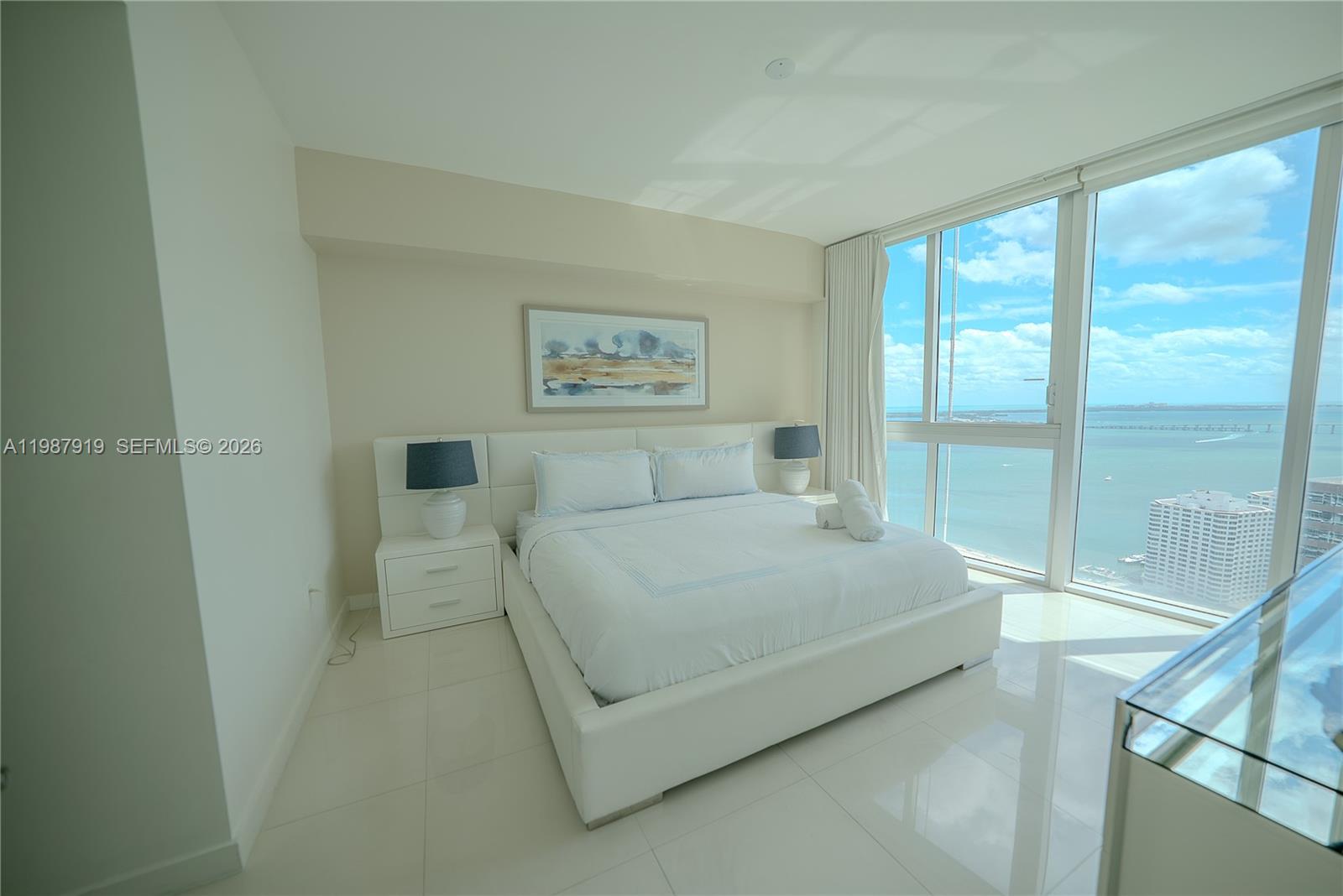 Icon Brickell Miami, FL 33131 - Photo 16 of 26 a bedroom with a bed lamp and a large window