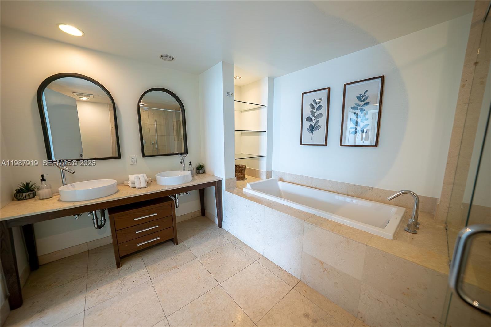 Icon Brickell Miami, FL 33131 - Photo 23 of 26 a spacious bathroom with a tub double sink and a mirror