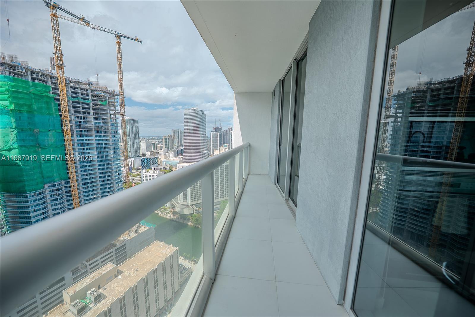 Icon Brickell Miami, FL 33131 - Photo 7 of 26 a view of balcony with floor to ceiling windows and wooden floor