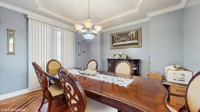 a view of a workspace room with furniture and a chandelier