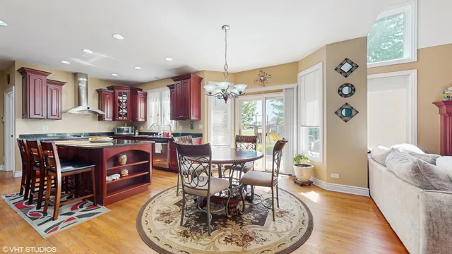 a living room with furniture a dining table and a chandelier