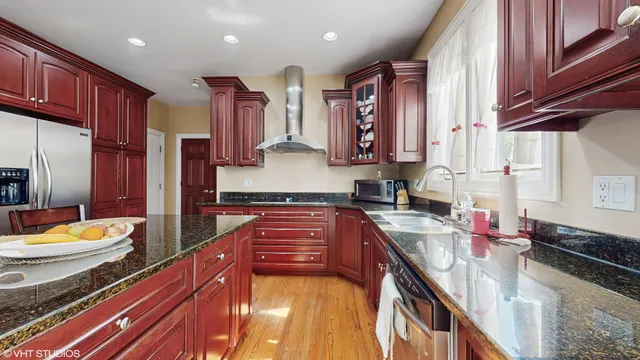 a kitchen with stainless steel appliances a sink stove and cabinets