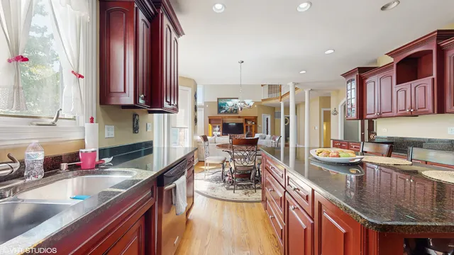 a kitchen with stainless steel appliances granite countertop a sink stove and cabinets