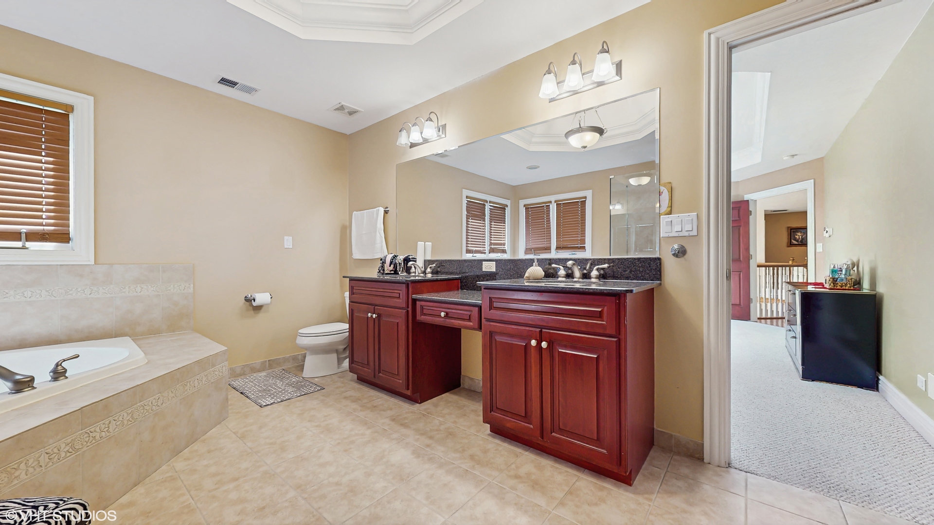 17040 Cheyenne Court Lockport, IL 60441 - Photo 27 of 47 a spacious bathroom with a granite countertop sink and a mirror