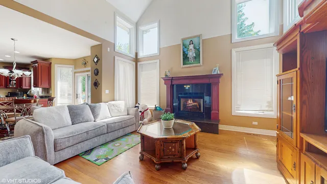 a living room with furniture a fireplace and a table
