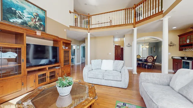 a living room with furniture a flat screen tv and a potted plant