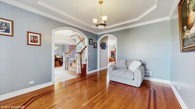 a living room with furniture and a chandelier
