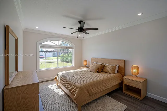 a bedroom with a large bed and a chandelier