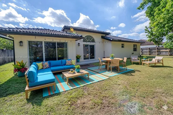 a view of a patio with table and chairs and potted plants