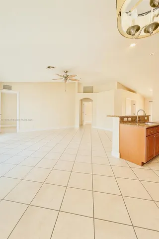 a view of a kitchen with white cabinets