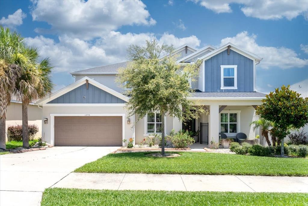 1296 Waterview Ridge Circle Apopka, FL 32703 - Photo 11 of 60 a front view of a house with a garden and plants