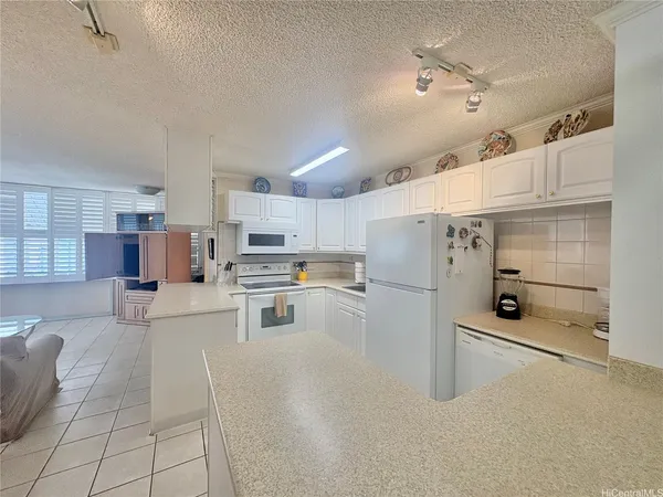 a kitchen with stainless steel appliances kitchen island granite countertop a sink and cabinets