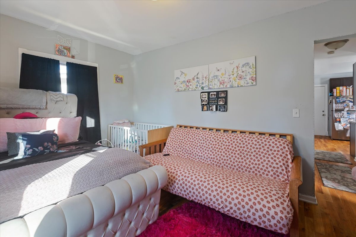 1213 Darrow Avenue Evanston, IL 60202 - Photo 4 of 16 a bedroom with a bed and wooden floor