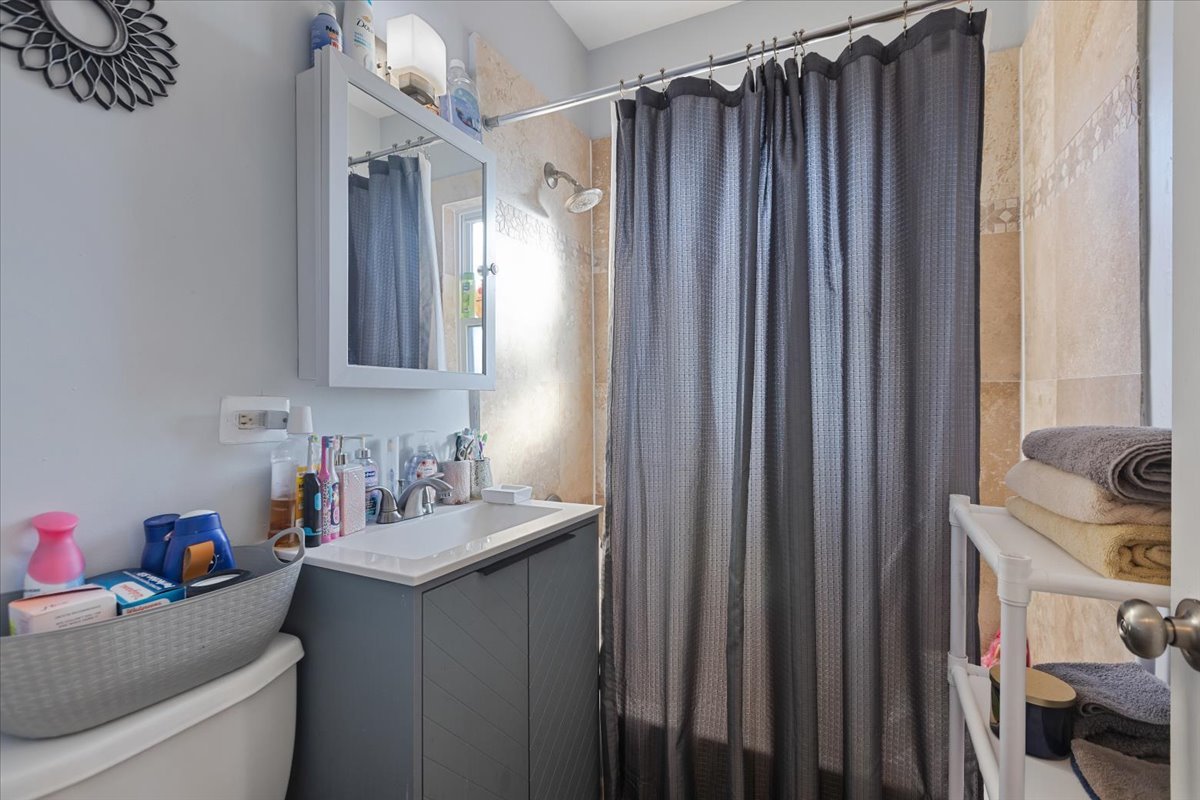 1213 Darrow Avenue Evanston, IL 60202 - Photo 10 of 16 a bathroom with a sink toilet and shower
