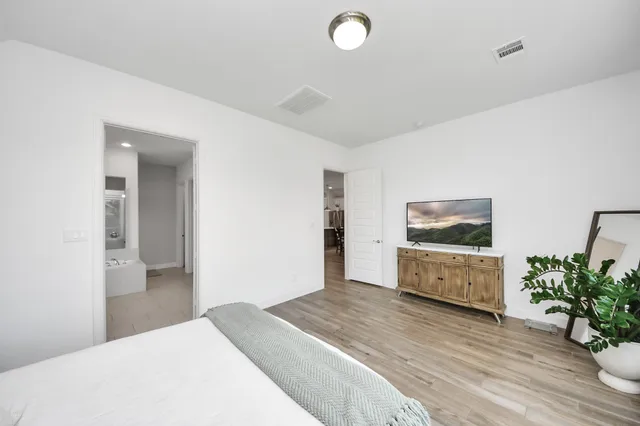 a bedroom with a bed and a flat screen tv