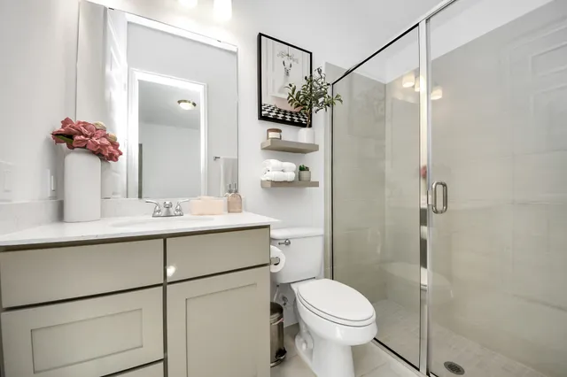 a bathroom with a sink toilet and shower