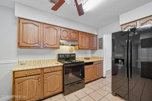 a kitchen with stainless steel appliances granite countertop a stove sink and cabinets