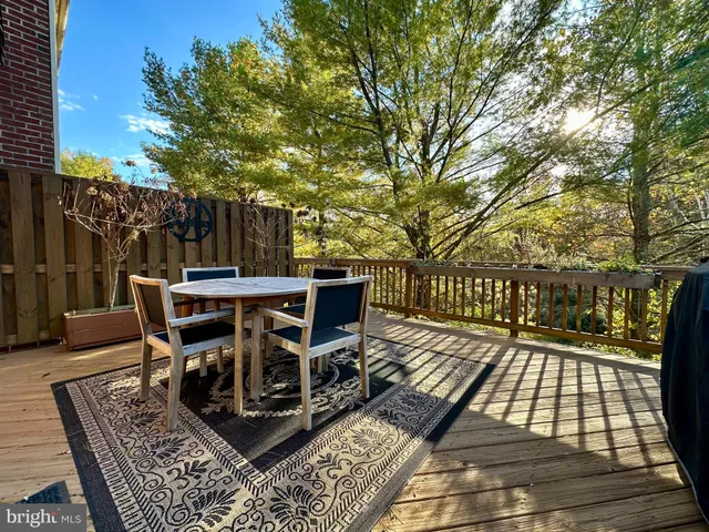 a view of a roof deck with table and chairs and wooden floor