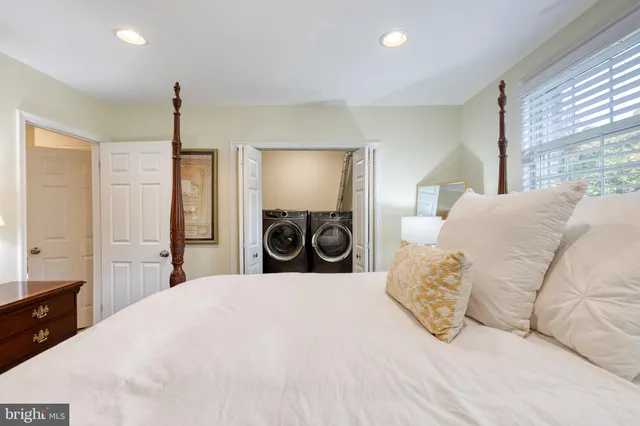 a large bedroom with a bed and a large window