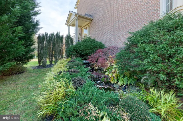 a front view of a house with a yard and garden