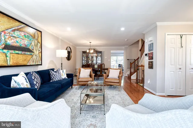 a living room with furniture wooden floor and a large window