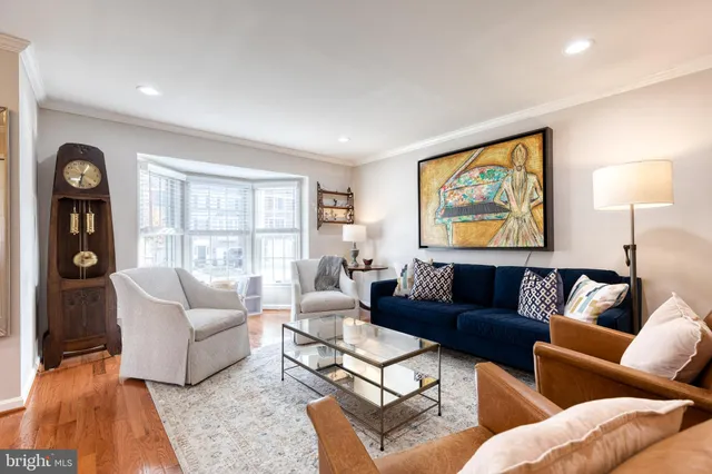 a living room with furniture a couch and a window