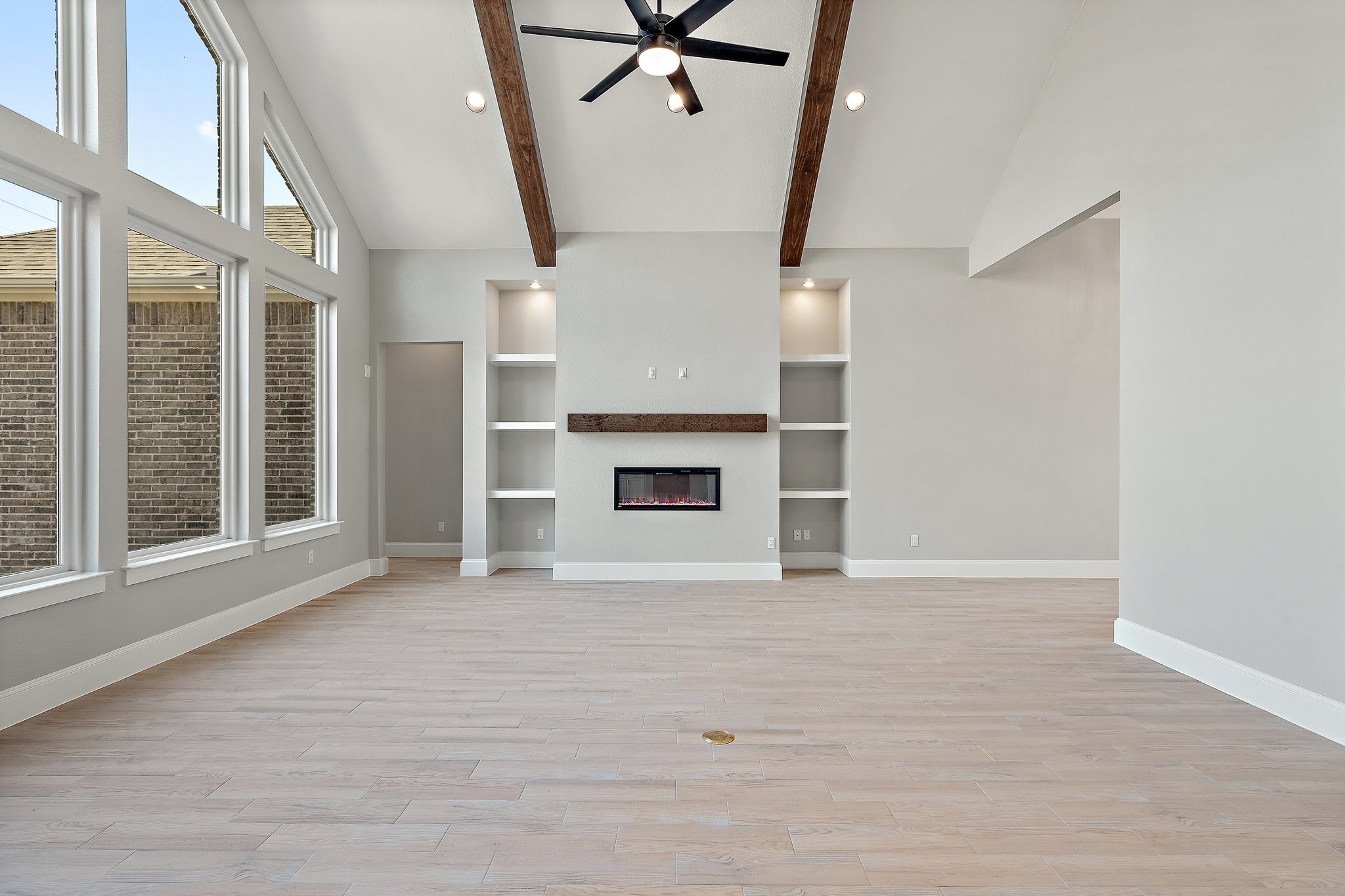 308 Axis Loop Georgetown, TX 78628 - Photo 11 of 40 an empty room with windows and fireplace