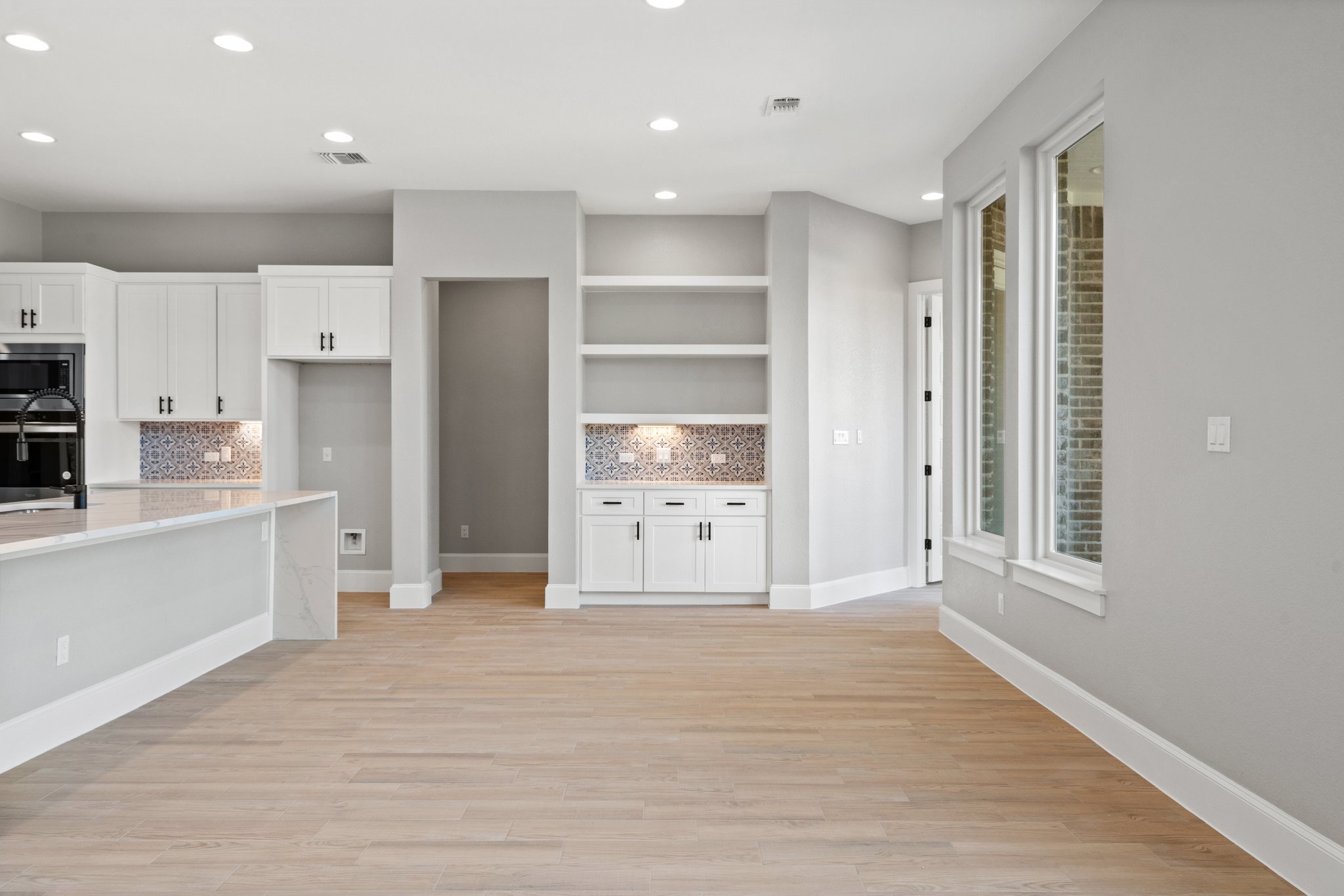 308 Axis Loop Georgetown, TX 78628 - Photo 19 of 40 a view of a kitchen with wooden floor and a refrigerator