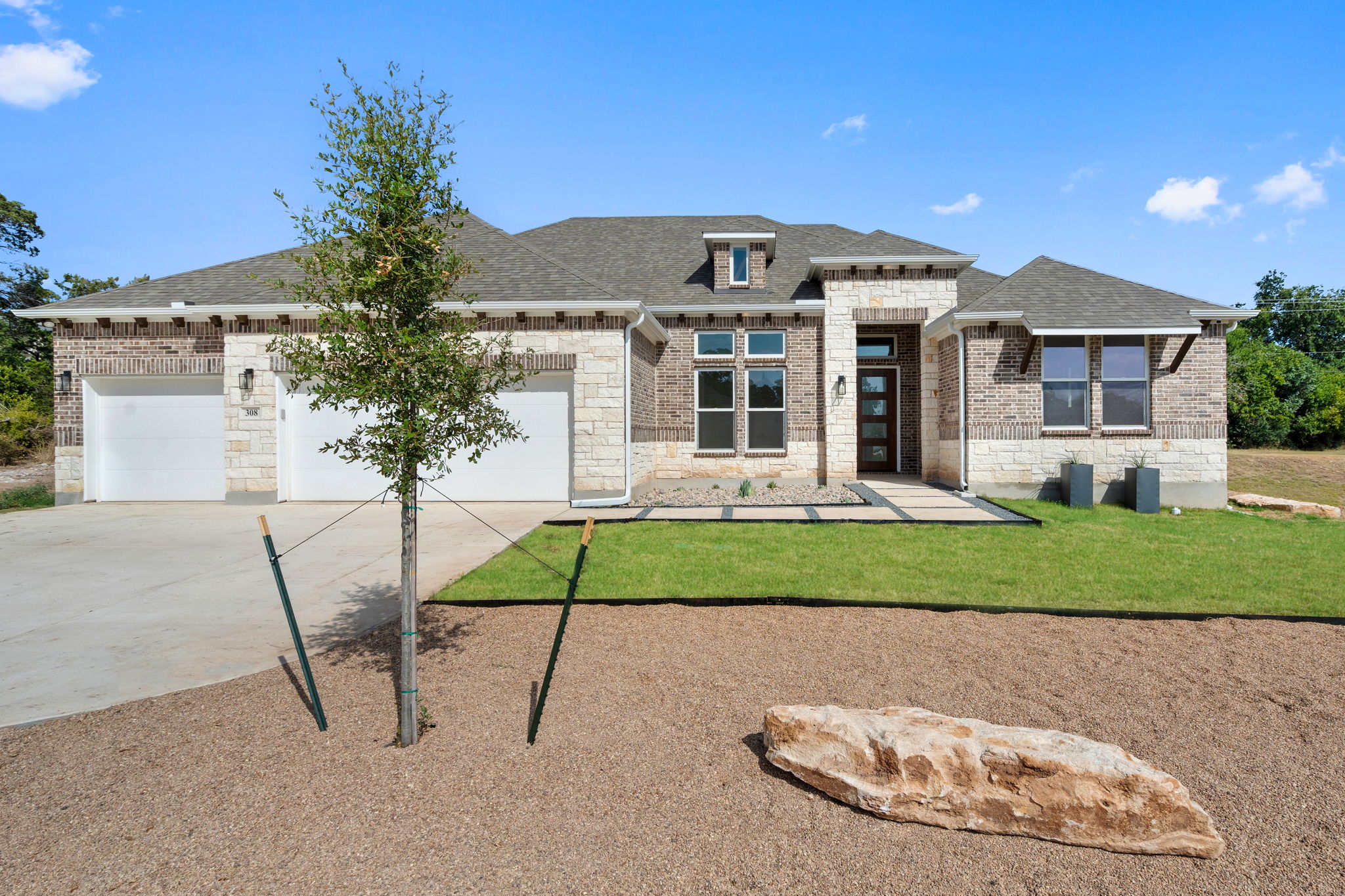 308 Axis Loop Georgetown, TX 78628 - Photo 2 of 40 a front view of a house with a yard and garage