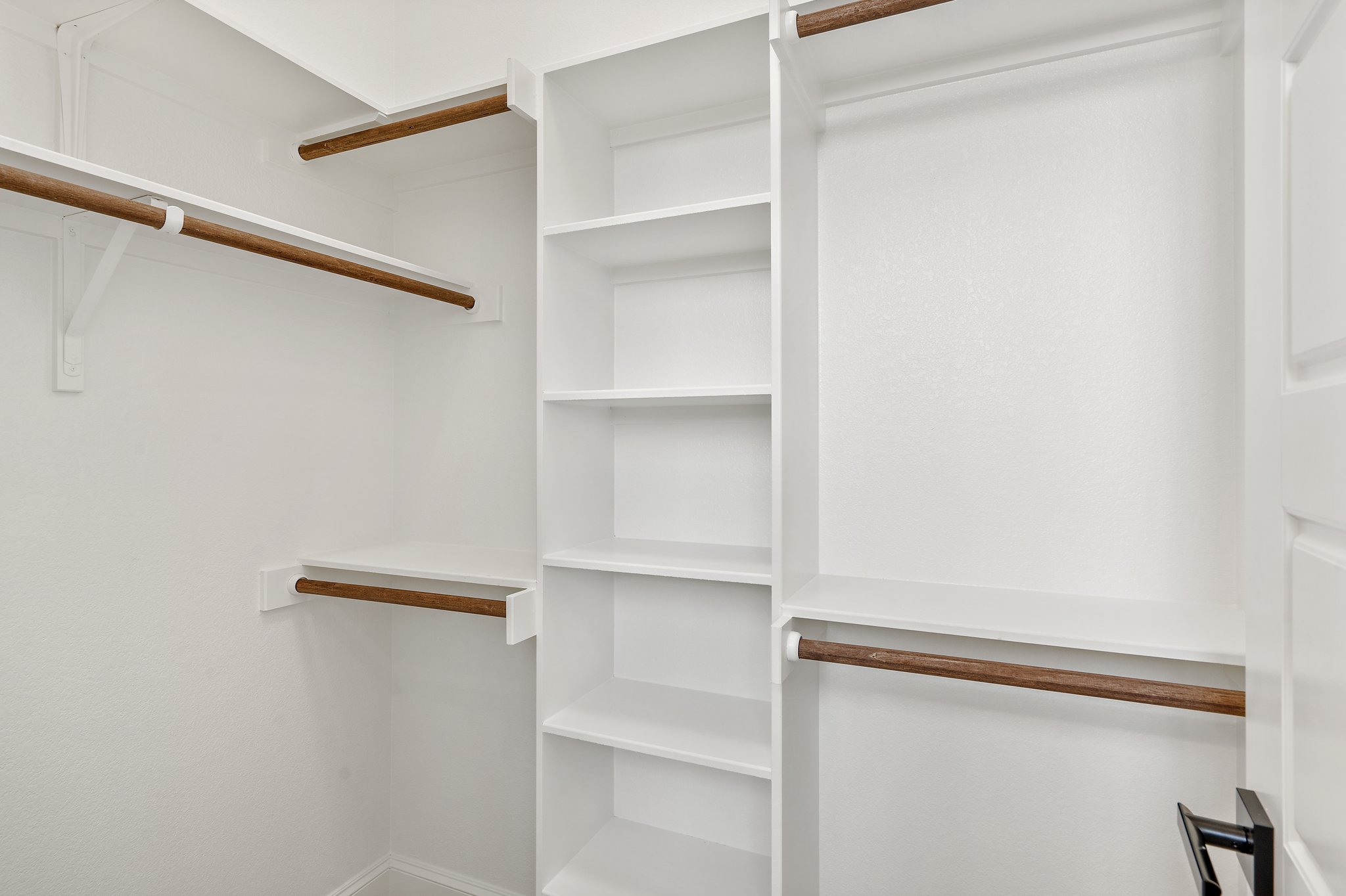 308 Axis Loop Georgetown, TX 78628 - Photo 25 of 40 a view of walk in closet with empty racks