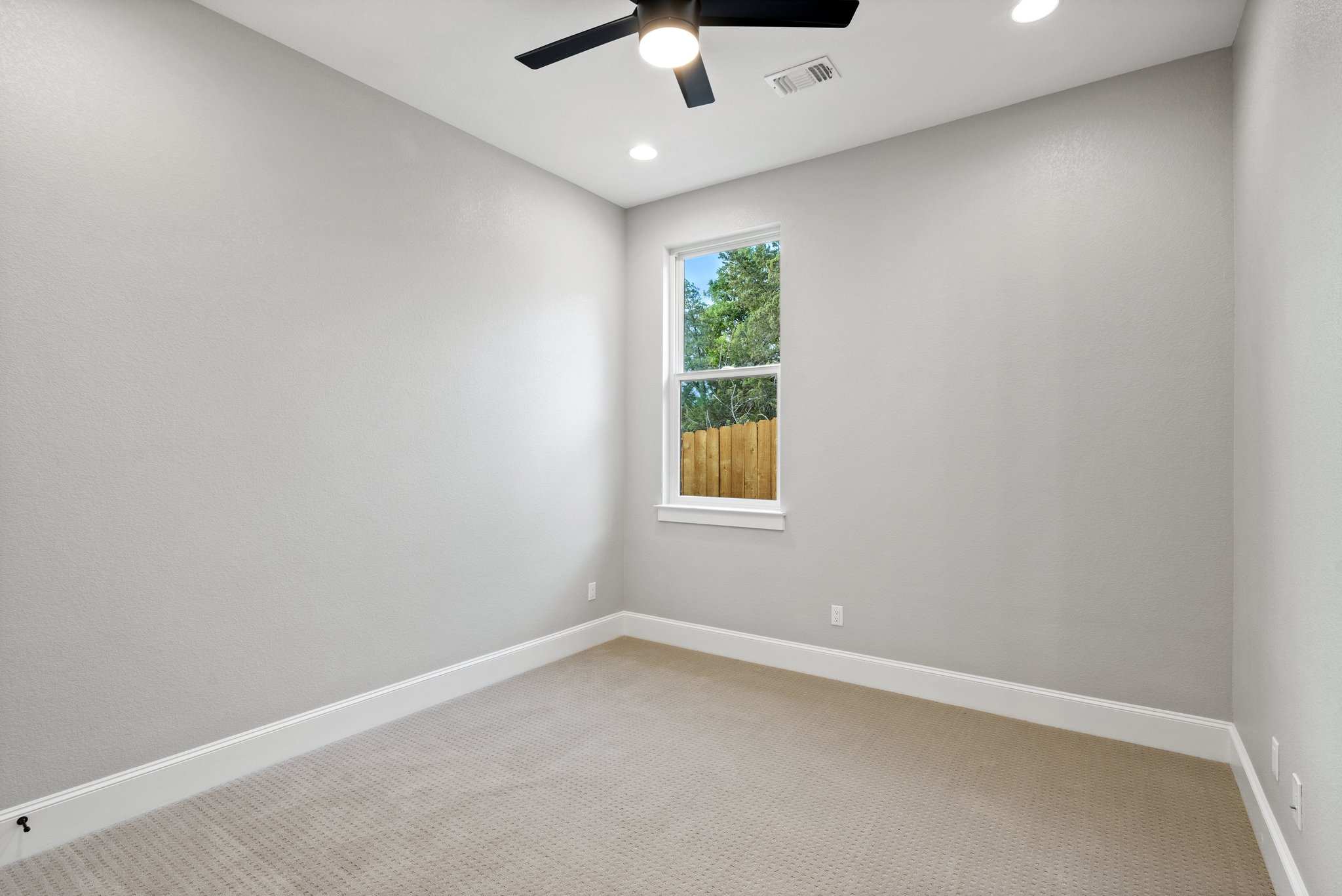 308 Axis Loop Georgetown, TX 78628 - Photo 29 of 40 an empty room with a window and a ceiling fan