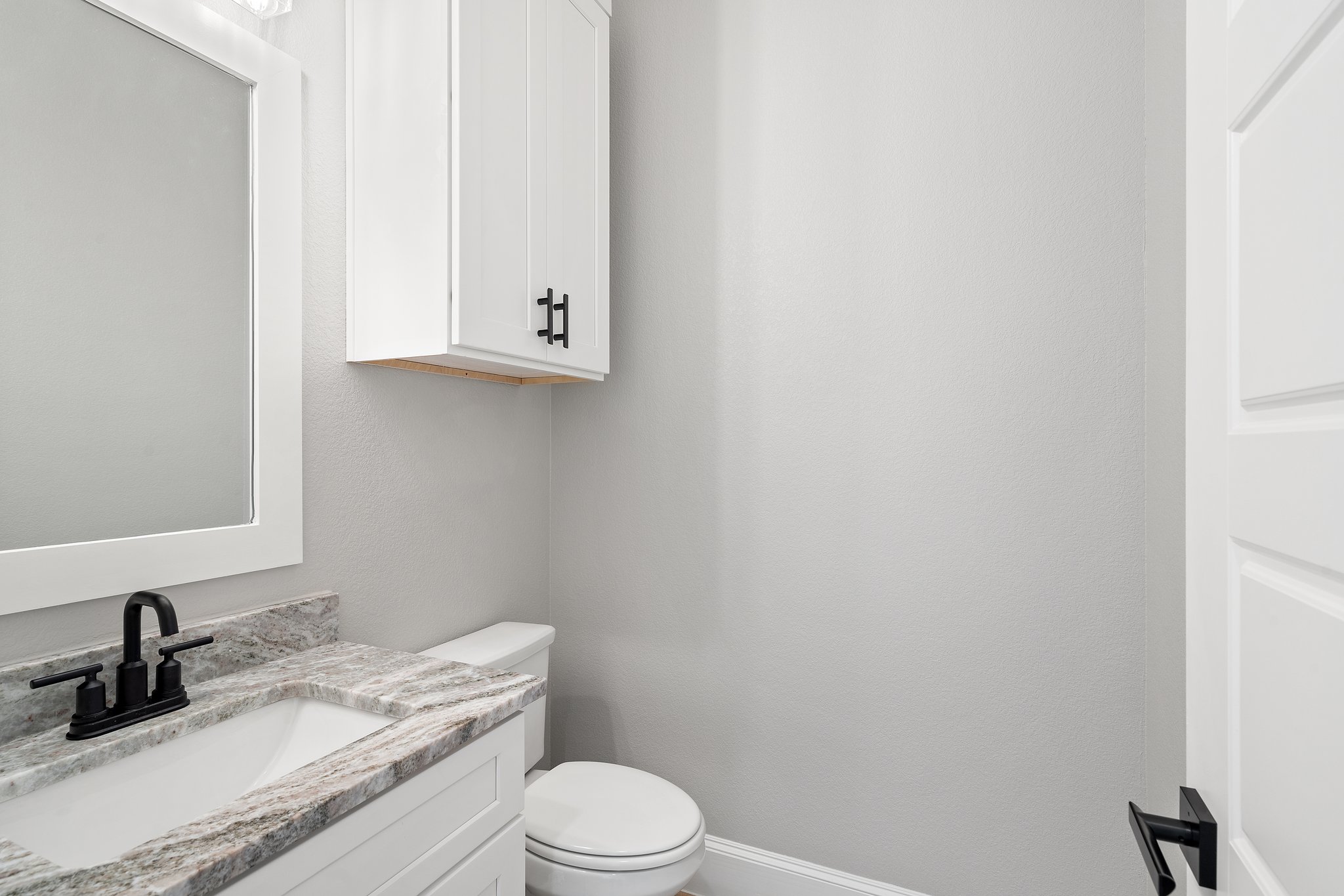 308 Axis Loop Georgetown, TX 78628 - Photo 6 of 40 a bathroom with a granite countertop toilet sink and mirror