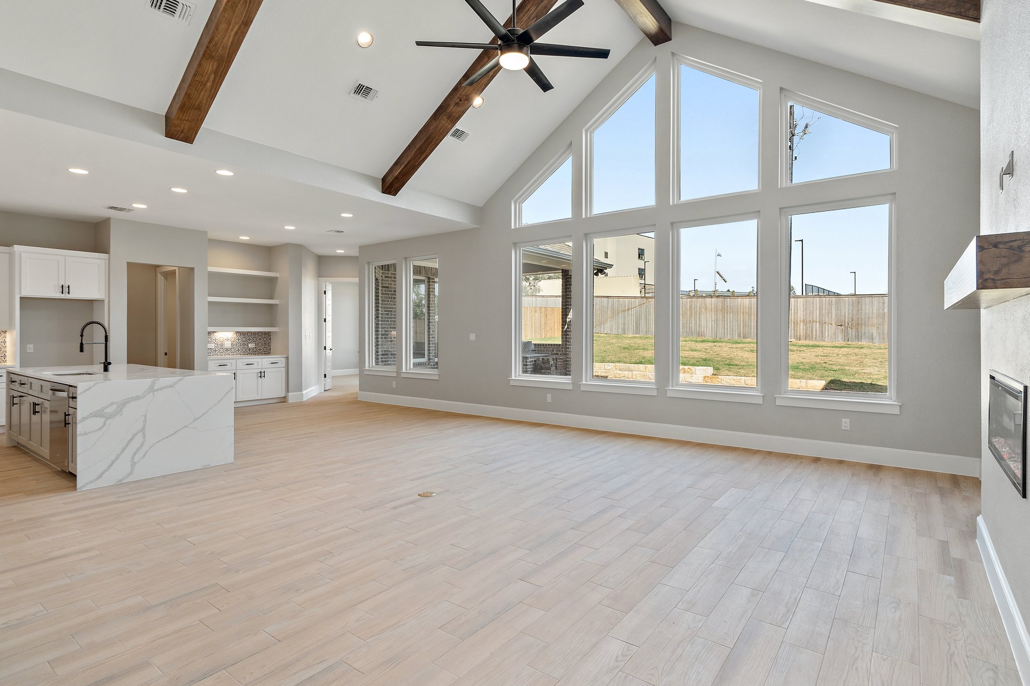 308 Axis Loop Georgetown, TX 78628 - Photo 10 of 40 a view of an empty room with a window and wooden floor