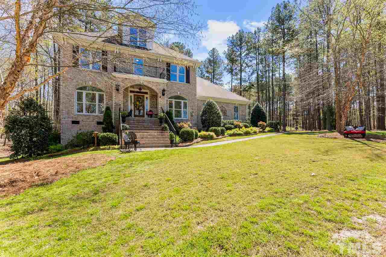 5512 Strathmore Drive Raleigh, NC 27613 - Photo 1 of 3 a front view of house with yard and trees in the background