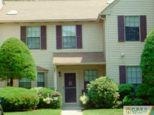 103 Maplecrest Road Edison, NJ 08820 - Photo 2 of 2 a view of a house with brick walls and potted plants