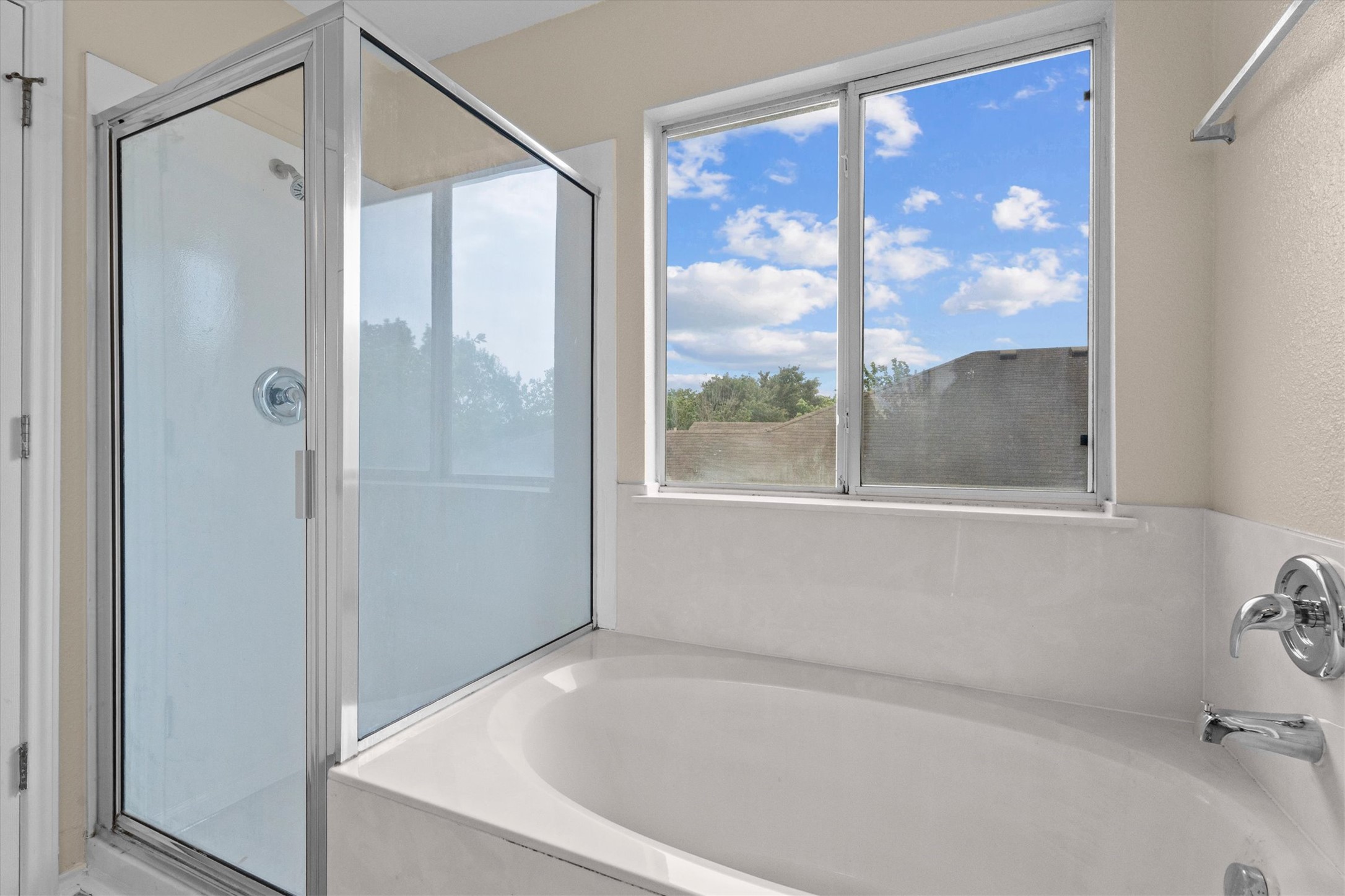 172 Discovery Kyle, TX 78640 - Photo 9 of 21 Relaxing primary bath with soaking tub, separate shower, and large window bringing in natural light.