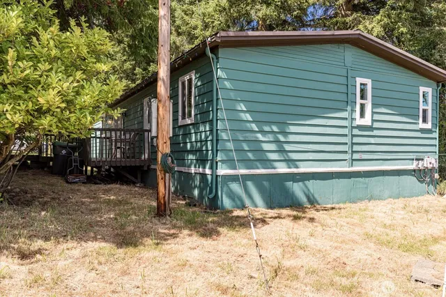 a small house with a tree in the background