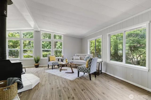 a living room with furniture and large windows
