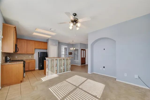 a open kitchen with stainless steel appliances granite countertop a refrigerator stove top oven and sink