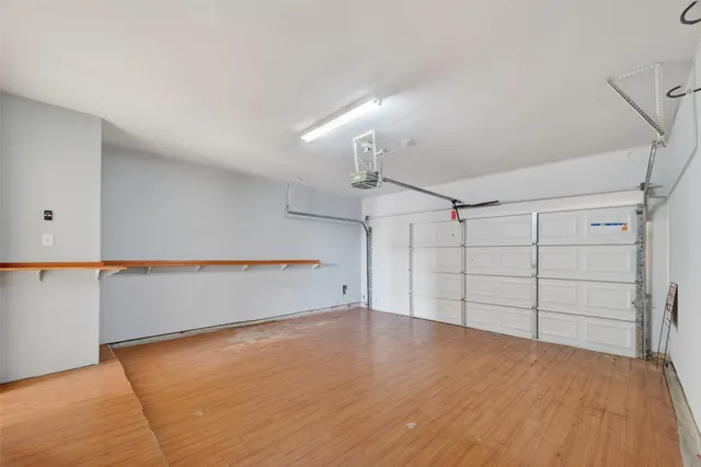 a view of a backyard with potted plants and wooden fence